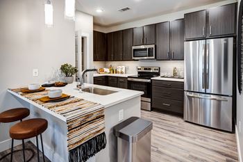 A modern kitchen with a bar stool and a countertop